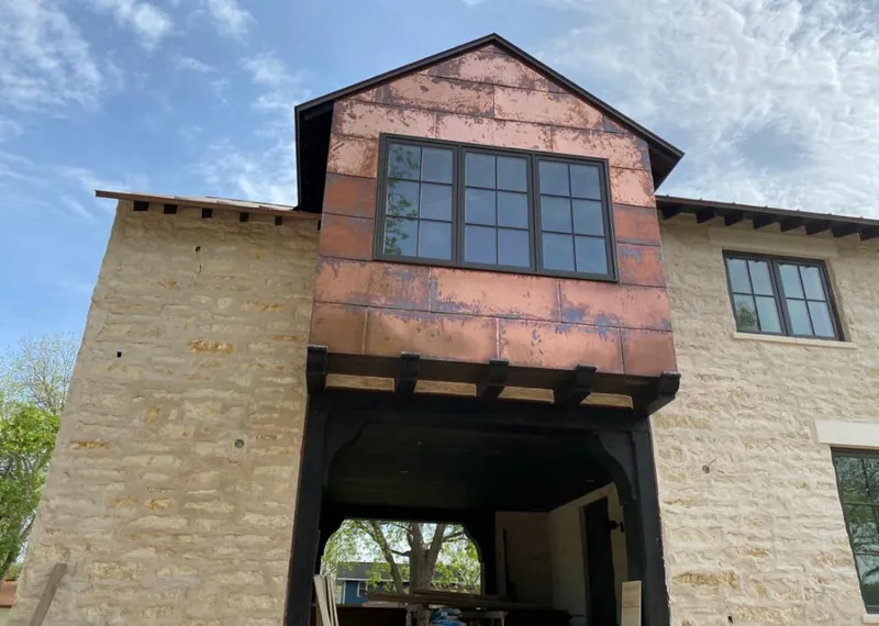 Copper metal panel facade on a stone building for Metal Roof Coating in Murrells Inlet